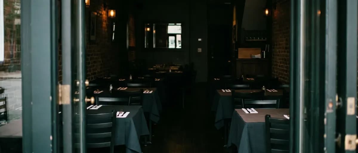 A restaurant dining room seen from the doorway before service